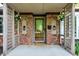 Charming covered entryway showcasing brick pillars, decorative sconces, and a welcoming front door at 8834 W 1050 S, Fortville, IN 46040