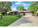 Lovely red brick ranch-style home featuring mature trees, green lawn and extended driveway at 8834 W 1050 S, Fortville, IN 46040