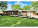 Charming red brick ranch home featuring a manicured lawn, bay window and attached garage at 8834 W 1050 S, Fortville, IN 46040