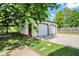 Two car detached garage with white siding and doors, plus an additional walk-in door and an ample driveway at 8834 W 1050 S, Fortville, IN 46040