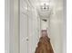 Long hallway with hardwood floors, closet and views into another room at 8834 W 1050 S, Fortville, IN 46040