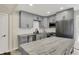 Contemporary kitchen with gray cabinets, stainless appliances, and a marble-topped island with pendant lighting at 8834 W 1050 S, Fortville, IN 46040