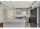Modern kitchen with grey cabinets, stainless steel appliances, and a white subway tile backsplash at 8834 W 1050 S, Fortville, IN 46040