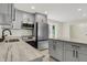 Modern kitchen features gray cabinets, stainless steel appliances, and marble countertops at 8834 W 1050 S, Fortville, IN 46040