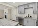The updated kitchen features stainless steel appliances, gray cabinets and gorgeous countertops at 8834 W 1050 S, Fortville, IN 46040