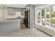 Stylish kitchen featuring grey cabinetry, stainless steel appliances, a center island, and a bright bay window at 8834 W 1050 S, Fortville, IN 46040