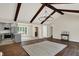 View of the living room with fireplace, exposed beams, and open concept at 8834 W 1050 S, Fortville, IN 46040