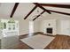 View of the living room with fireplace, wood floors and exposed beams at 8834 W 1050 S, Fortville, IN 46040