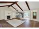 View of the living room and kitchen with fireplace and exposed beams at 8834 W 1050 S, Fortville, IN 46040