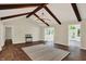 Living room features wood flooring, exposed beams, and plenty of natural light at 8834 W 1050 S, Fortville, IN 46040