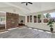 Bright sun room with large windows, brick accent wall and hardwood style floors at 8834 W 1050 S, Fortville, IN 46040
