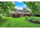 Spacious backyard featuring a large brick home, mature trees, and lush green lawn at 9036 Buckeye Ct, Indianapolis, IN 46260