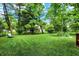 Expansive, well-maintained backyard offering ample green space and mature trees at 9036 Buckeye Ct, Indianapolis, IN 46260