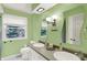 Bright bathroom featuring double sinks, a window, and modern fixtures at 9036 Buckeye Ct, Indianapolis, IN 46260