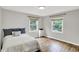 Bedroom with wood floors, gray walls, large windows, and a bed at 9036 Buckeye Ct, Indianapolis, IN 46260