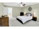 A view of the bedroom with a ceiling fan, light green walls, and gray carpet at 9036 Buckeye Ct, Indianapolis, IN 46260