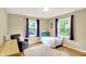 Bedroom with hardwood floors, neutral walls, two windows and a full-sized bed at 9036 Buckeye Ct, Indianapolis, IN 46260