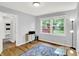 Bedroom with hardwood flooring, neutral paint, and natural light from the large window at 9036 Buckeye Ct, Indianapolis, IN 46260