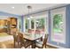 Dining area adjacent to the kitchen, featuring a wooden table, backyard view, and natural light at 9036 Buckeye Ct, Indianapolis, IN 46260