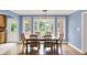 Dining room with large windows offering backyard views and wooden table with seating for six at 9036 Buckeye Ct, Indianapolis, IN 46260