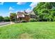 Charming Tudor-style home with well-manicured lawn and mature trees at 9036 Buckeye Ct, Indianapolis, IN 46260