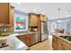Bright kitchen featuring granite countertops, stainless steel appliances, and views of the backyard at 9036 Buckeye Ct, Indianapolis, IN 46260