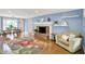 Bright living room featuring a brick fireplace, hardwood floors, and ample natural light at 9036 Buckeye Ct, Indianapolis, IN 46260