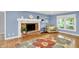 Cozy living room featuring a brick fireplace, large window, and comfortable seating area at 9036 Buckeye Ct, Indianapolis, IN 46260