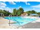 Outdoor pool with clear water, lane markers, diving blocks and poolside furniture at 9036 Buckeye Ct, Indianapolis, IN 46260