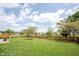 Spacious backyard with a wood fence, lush green lawn, and a tranquil pond view at 905 N Main St, Fortville, IN 46040