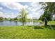 Picturesque backyard featuring a serene pond and swing, perfect for relaxing and enjoying the outdoors at 905 N Main St, Fortville, IN 46040
