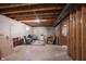 Unfinished basement featuring a concrete floor, an exposed ceiling, and furniture set at 905 N Main St, Fortville, IN 46040