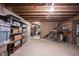 Unfinished basement with exposed wood ceiling, concrete floor, and plenty of room for storage at 905 N Main St, Fortville, IN 46040