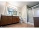 Bathroom featuring a double sink vanity and glass-enclosed shower at 905 N Main St, Fortville, IN 46040