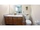 Bathroom with double sink vanity, toilet, and decorative wall hangings at 905 N Main St, Fortville, IN 46040