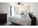 Spacious bedroom with ceiling fan, dresser, and window with drapes at 905 N Main St, Fortville, IN 46040