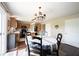Cozy dining area features a chandelier, wood floors, and access to the kitchen at 905 N Main St, Fortville, IN 46040