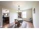 The dining area features a chandelier, table, and rug, offering a cozy space for meals at 905 N Main St, Fortville, IN 46040
