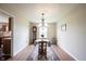 The dining area features a chandelier and a rug, providing an inviting space for gatherings at 905 N Main St, Fortville, IN 46040