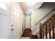 Bright entryway with hardwood floors, staircase, and front door at 905 N Main St, Fortville, IN 46040