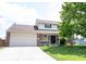 Charming two-story home featuring a brick-and-vinyl facade, attached garage, and well-manicured front yard at 905 N Main St, Fortville, IN 46040