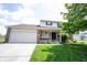 Charming two-story home with a brick facade, attached garage, and well-manicured lawn at 905 N Main St, Fortville, IN 46040
