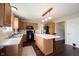 Functional kitchen with wooden cabinets, black appliances, white countertops, and a center island at 905 N Main St, Fortville, IN 46040