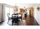 Well-lit kitchen and dining area with wood cabinets, island seating, and access to outdoor patio at 905 N Main St, Fortville, IN 46040