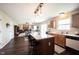 Open kitchen with an island, stainless steel appliances, and views of the living room at 905 N Main St, Fortville, IN 46040