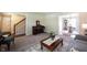 Living room featuring a piano and a staircase, adding character to the space at 905 N Main St, Fortville, IN 46040