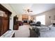 Spacious living room with a brick fireplace, ceiling fan, and comfortable seating at 905 N Main St, Fortville, IN 46040