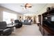 Bright living room with a ceiling fan and an open layout leading to the kitchen at 905 N Main St, Fortville, IN 46040