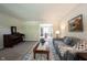Cozy living room with piano, area rug, and view to the dining room at 905 N Main St, Fortville, IN 46040