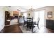 Open-concept living and dining area with a brick fireplace, hardwood floors, and lots of natural light at 905 N Main St, Fortville, IN 46040